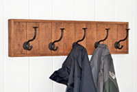 Wooden wall mounted coat rack with cast iron hooks